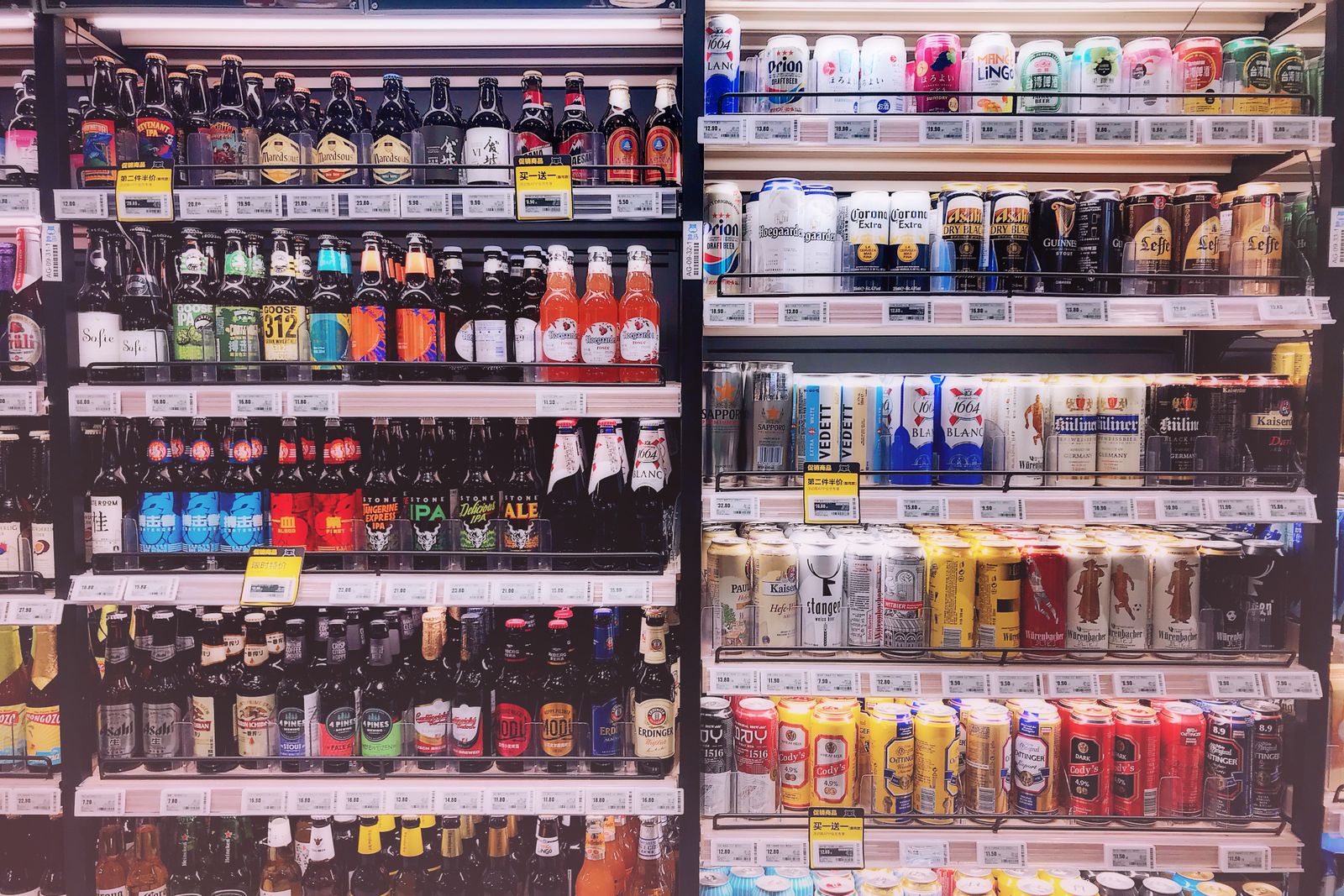 A stocked cold case of beer, singles to cases