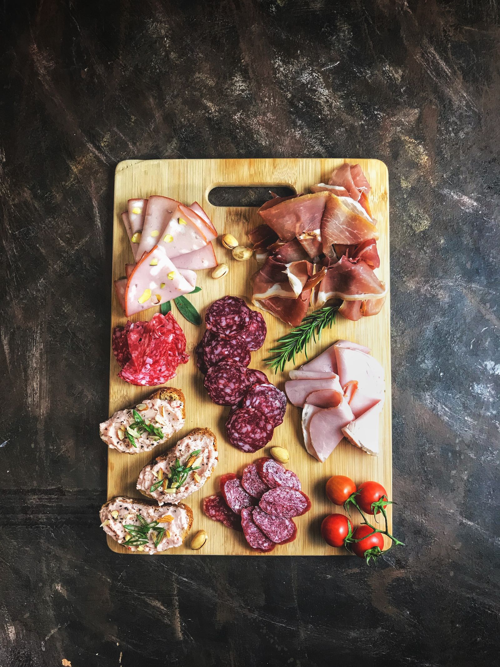 A board of sliced cold cuts and cured meats